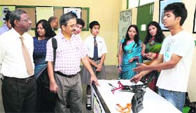 A student gives discription to visitors about his model at the annual exhibition on robotics and art at Raja Rammohan Roy Academy in Dehradun on Thursday.