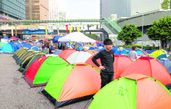 Protesters camp on a main road leading to the financial central district in Hong Kong on Thursday.   Reuters