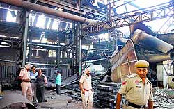 Police officials inspect the blast site in Ludhiana