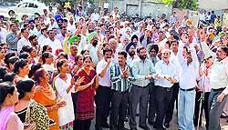 Protesters hold a protest outside the State Bank of India near Fountain Chowk in Ludhiana on Friday