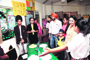 A student explains her model at the annual exhibition of Ecole Globale School in Dehradun on Friday