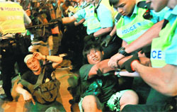 Protesters are dragged away by the riot police during a confrontation at Mongkok shopping district in Hong Kong on Friday. Reuters