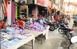 Footpath encroached upon in Dhobi Bazar area of Bathinda on Saturday. Tribune photo