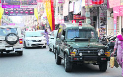 Vehicles parked in a haphazard manner in Dhobi Bazaar create traffic problems. Tribune photo