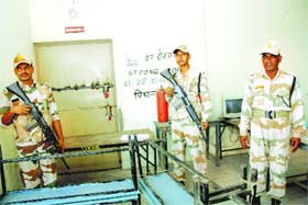 Security personnel stand guard outside the strongroom in Rohtak on Saturday