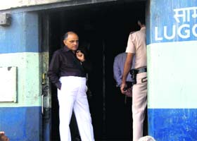 Officials take stock of the situation after a train bogie caught fire at the Rewari railway station on Saturday