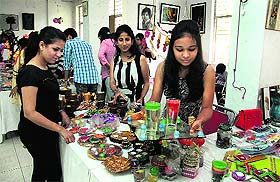 Students of the Apeejay College of Fine Arts show their work to the customers during Diwali Mela at Virsa Vihar at Jalandhar. 