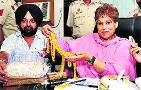 An official shows the gold and diamond ornaments which were seized by the department without bills in Jalandhar on Saturday. 