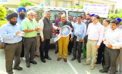 Executive Director, Power Grid, Northern Region-II, SK Sharma hands over the key of an ambulance to Principal, Government Medical College, Patiala. A Tribune photograph 