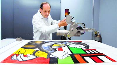 Dr Killian Anheuser, head scientist at the Fine Arts Experts Institute, analyses a bold-coloured painting in Geneva purportedly by French master Fernand Leger, searching for signs of forgery.