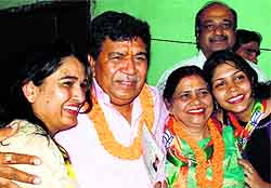 Gian Chand Gupta, BJP candidate from Panchkula, being greeted by his wife (second from right) and daughter (right) after his victory on Sunday
