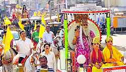 Devotees participate in a procession to mark Vishwakarma Jayanti in Jammu on Sunday