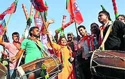 Celebration time: BJP supporters in Jammu celebrate the partys victory in the Assembly elections in Haryana and Maharashtra on Sunday