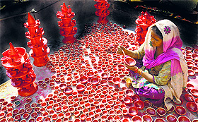 A potter paints an earthen lamp in Ludhiana.