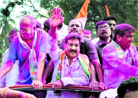 Congress leader Prithviraj Chavan waves to supporters at a victory procession after his win from the Karad South Assembly seat on Sunday