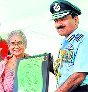 Air Chief Marshal Arup Raha presents lifetime achievement award to KPK Tandon of Punjab Public School in Nabha on Sunday. 