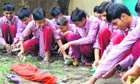 Visually challenged students from Swami Azranand Blind School in Bhoopatwala collect garbage in Haridwar on Sunday