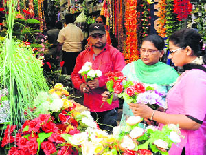 Women purchase flowers ahead of Diwali at Dhobi Bazaar in Bathinda on Monday.