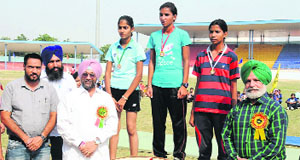 MLA of Talwandi Sabo, Jeetmohinder Singh Sidhu, felicitates the winners of the 800 meter race during the womens sports competition in Bathinda on Monday.