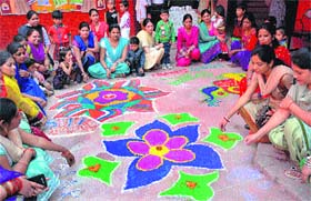 Parents and mothers along with students take part in rangoli-making during the Diwali celebrations at Tribune Model School, Sector 29, in Chandigarh on Monday