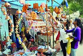 Girls shop for Diwali at Sarojini Nagar Market in New Delhi on Monday.