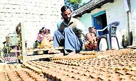 A potter makes earthen lamps ahead of Diwali at a village in Mandi. 