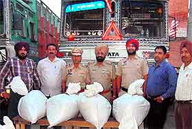 The Jalandhar rural police special staff team along with the seized poppy husk in Jalandhar on Monday. 