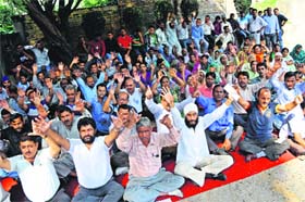Employees of the Estates Department protest in Jammu on Monday