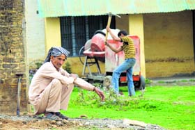 A labourer works at a construction site in Jandrah village of Jammu