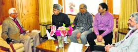 Governor NN Vohra interacts with a delegation which called on him to discuss flood relief work in Srinagar on Monday