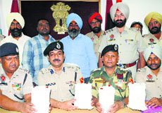 BSF and Punjab Police officers with seized heroin.