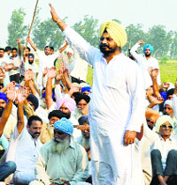 Congress MLA Kuljeet Singh Nagra leads a protest at Reona Ucha village on Monday.