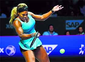 Serena Williams returns to Ana Ivanovic during their Tour Finals match in Singapore on Monday. 