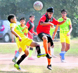 Players of Saupins School and St Xaviers Senior Secondary School vie for the ball during a match played in Chandigarh on Tuesday. 