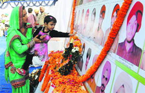 A mother-child duo pays tributes to police martyrs on Police Commemoration Day at Phase VII police station in Mohali on Tuesday. 