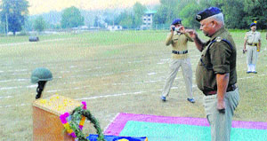 ASP Nihal Chand pays floral tributes to police martyrs at the Police Lines in Bashing in Kullu on Tuesday.