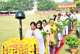 Family members of martyrs lay wreaths at a memorial during the Police Commemoration Day ceremony at Gulshan Ground in Jammu on Tuesday