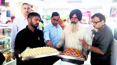 Health officials inspect sweets at the shop in Ludhiana. 