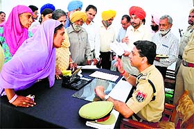 Police Commissioner Parmod Ban listens to the grievances of kin of police martyrs during a function in Ludhiana.