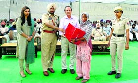 A family member of a martyr being felicitated during the Commemoration Day in Jagraon. 