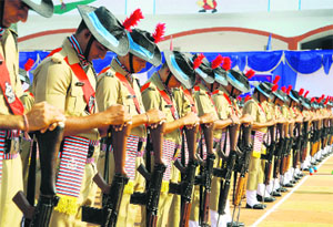 Policemen reverse their arms to pay homage to martyrs at the Police Commemoration Day parade at the police lines in Dehradun on Tuesday.