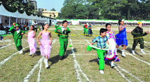 Students participate in a race during the annual sports day of St. Thomas College in Dehradun on Tuesday.