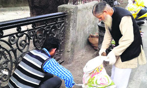 Cleanliness drive being carried out on Mall Road in Mussoorie on Tuesday.
