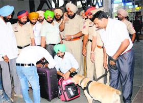Police officials check luggage of passengers as part of the security drive ahead of Diwali at the railway station in Amritsar