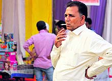 a man openly smokes in the cracker market at the Multi-Purpose Stadium in Bathinda on Wednesday