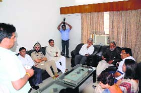Union Minister Krishan Pal Gurjar talks to one of the cracker stall owners in Faridabad on Wednesday