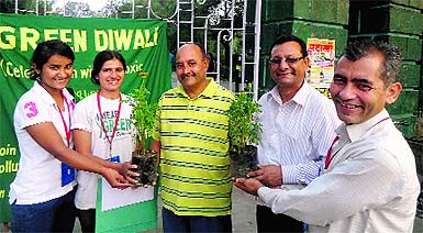 Activists of the U Turn Foundation gives saplings to people as part of the pollution-free Diwali campaign at Gandhi Park in Dehradun on Wednesday.
