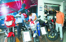 Customers have a look at motorcycles at a showroom in Amritsar.
