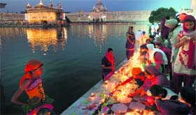 Devotees light candles and lamps at the Golden Temple on Diwali and Bandi Chor Diwas in Amritsar.