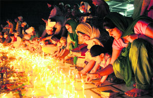 Devotees light candles at the Gurdwara Qila Mubarak on the night of Diwali in Bathinda.